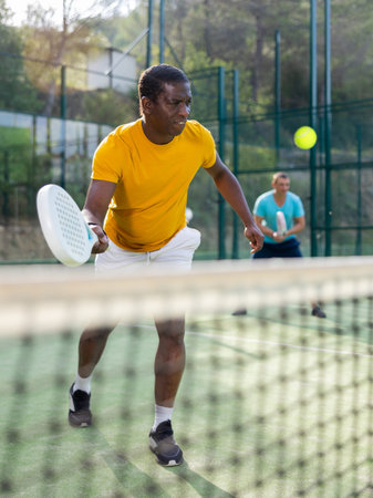 Man playing padel tennis on court