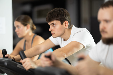 Guy is exercising on an exercise bike