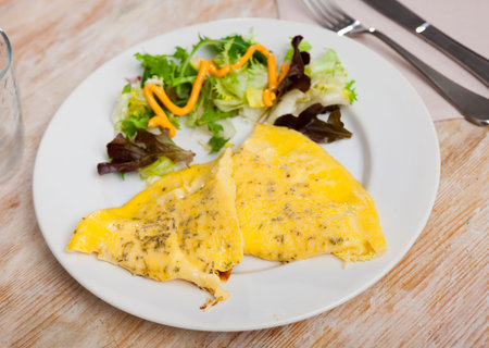 Omelet with salad of fresh lettuce for breakfast