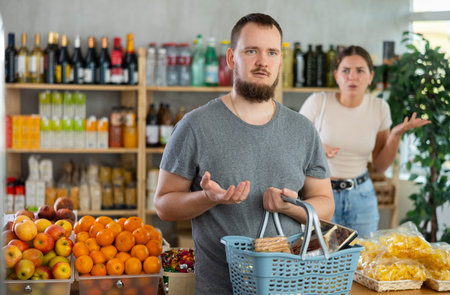 Young woman quarrels with man in grocery store