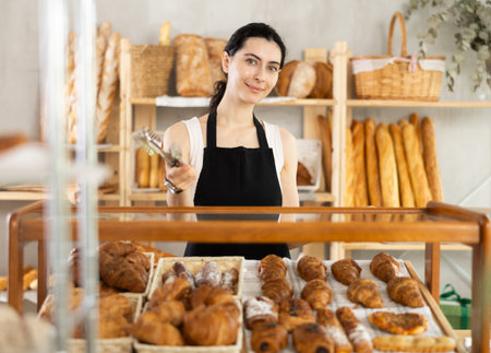 Armenian young woman work selling in family bakery shop