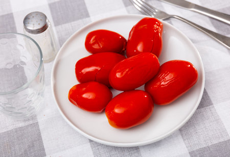 Healthy homemade delicious savory pickled tomatoes on plateの写真素材