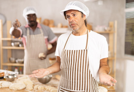 Upset baker reprimanded by boss in small bakery