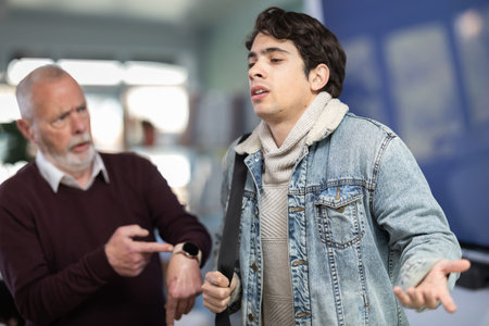 Upset guy employee of company quits job, and mature manager shouts after him.