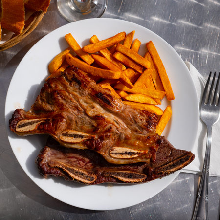 Portion of fried potatoes with beef steak