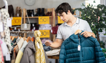 In chain shop, guy choose down jacket