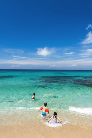 Family with kids by the beachの写真素材