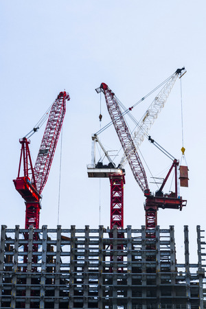 Construction site with cranes on sky backgroundの写真素材