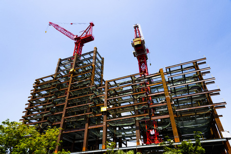 Construction site with cranes on sky backgroundの写真素材