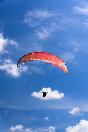 Paragliding extreme Sport with blue Sky and clouds on background Healthy Lifestyle and Freedom conceptの写真素材