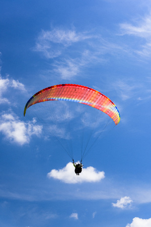 Paragliding extreme Sport with blue Sky and cloudsの写真素材