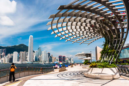 Tourists visiting the Avenue of the Stars. The Avenue of Stars is located along the Victoria Harbor in Hong Kong.のeditorial素材