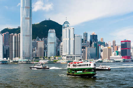 Star Ferry on the way to Central Pier harbor with hong kong's skyscrapers in the backgroundのeditorial素材