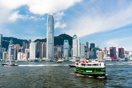 Star Ferry on the way to Central Pier harbor with hong kong's skyscrapers in the background