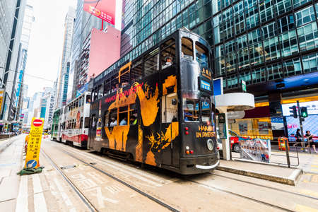 View of famous double-decker trams with the background of the Modern building in Hong Kong Island.のeditorial素材