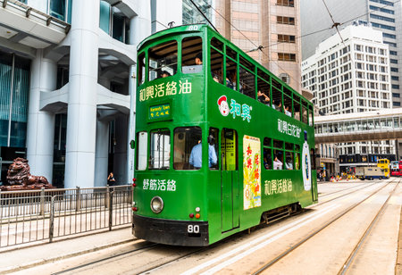 Famous double-decker trams with the background of the Modern building in Hong Kong Island.のeditorial素材