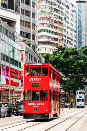 the double-decker trams on the street of Wan Chai in Hong Kong. Wan Chai is one of the busiest commercial areas in Hong Kong.のeditorial素材