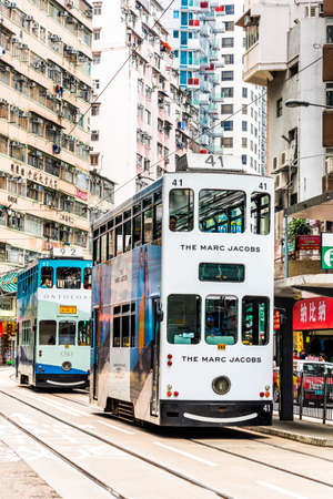 the double-decker trams on the street of Wan Chai in Hong Kong. Wan Chai is one of the busiest commercial areas in Hong Kong.のeditorial素材