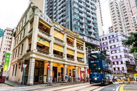 Famous double-decker trams with Wo Cheong Pawnshop in Hong Kong.のeditorial素材