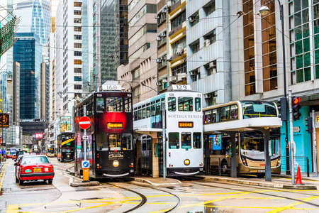 View of famous double-decker trams with the background of the Modern building in Hong Kong Island.のeditorial素材