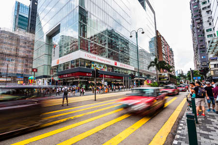 People crossing Street near Chungking Mansions, Nathan Road, Hong kong.のeditorial素材