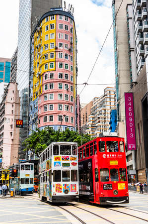 the double-decker trams on the street of Wan Chai in Hong Kong. Wan Chai is one of the busiest commercial areas in Hong Kong.のeditorial素材
