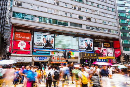 Pedestrians cross the road past the famous Chungking Mansions building in Hong Kong.のeditorial素材