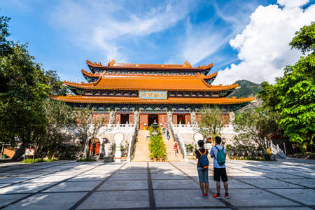 Main hall of Po Lin Monastery, Hong Kong. The text above the door reads Daxiong Baodian, meaning Hall of Great Strength.のeditorial素材