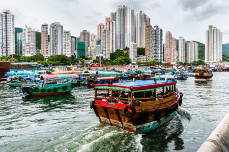 2019: Traditional fishing trawler in the Aberdeen Bay. Famous floating village in Aberdeen is an area and town on the south shore of Hong Kong Islandのeditorial素材