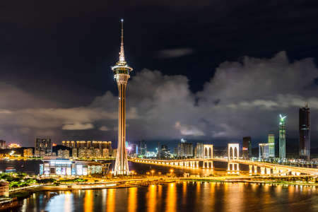 Beautiful night view of Macau Tower and Sai Van Bridge crossing Praia Grande Bay (Nam Van) and connecting Taipa Island and Macau Peninsula. Amazing Macao skyline. Wonderful cityscape.のeditorial素材