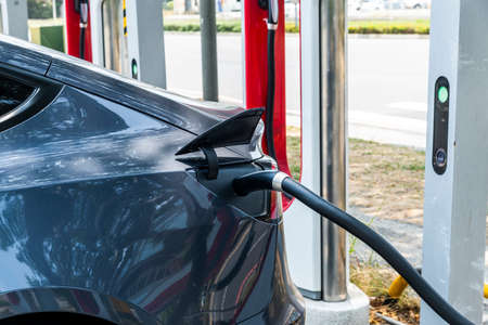 close-up of Tesla electric vehicle while parked at Tesla charger station.のeditorial素材