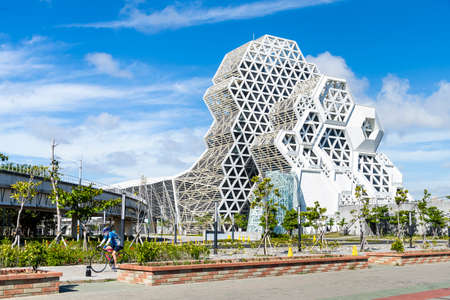Kaohsiung, Taiwan- May 6, 2021: Kaohsiung Music Center with a view from Love River. The white hexagonal building structure on the riverbank in Kaohsiung, Taiwan.のeditorial素材