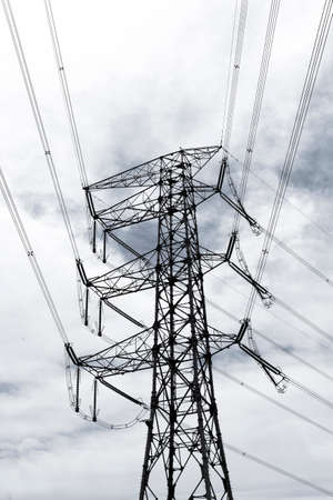Silhouette of high voltage tower and electric line with the sky backgroundの写真素材