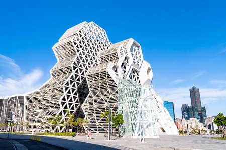 Kaohsiung Music Center with a view from Love River. The white hexagonal building structure on the riverbank in Kaohsiung, Taiwan.のeditorial素材