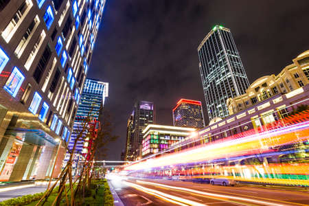 Low angle view of modern commercial buildings at night in the Xinyi District of Taipei, Taiwan.のeditorial素材