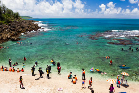 Tourists are preparing to dive off the beach of Wanlitong in Kenting National Park, Pingtung, Taiwan.のeditorial素材
