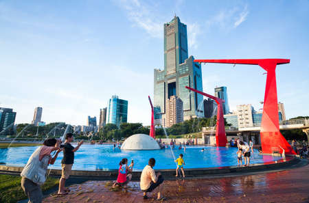 Tourists are playing in the red fountain at Singuang Ferry Wharf in Kaohsiung, Taiwan.のeditorial素材