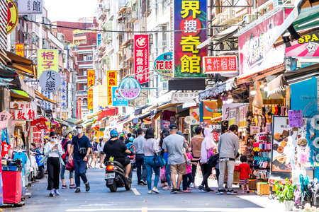Tourists wearing a mask are visiting Tamsui Old Street in New Taipei City, Taiwan. here is a famous tourist attraction in Taiwan.のeditorial素材