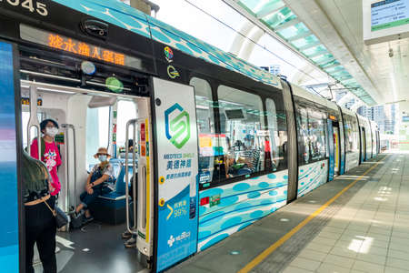 During the coronavirus(COVID-19) outbreak, Passengers wearing a mask board the light rail MRT at Tamsui Station in New Taipei City, Taiwan.のeditorial素材