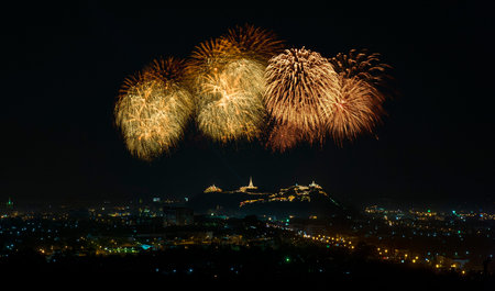 Big colorful fireworks over the palace on the mountain top in Thailandの写真素材