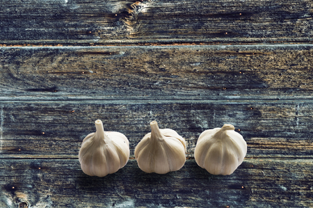 Garlic on vintage blue brown color wood texture backgroundの写真素材