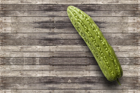 Bitter melon on wooden background, Momordica charantia L.Cucurbitaceae, Bitter cucumber-chineseの写真素材