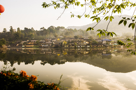 Tribal high hill village locate at the river bank with water reflection, sun rise warm tone, peace mind, freshの写真素材