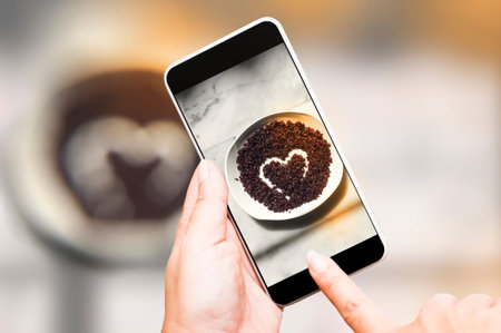 Taka a photo Thai jasmine black rice berry with smartphone. Cooked rice in heart shape on white...