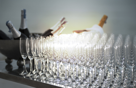 Set of wineglass and wine bottles on luxury beach dinning party at sunset.の写真素材