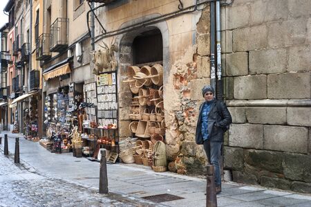 MADRID, SPAIN - April 11, 2018: Tourist walking in front of souvenir shops at Segovia the historic city Romanesque architecture locate at northwest of Madrid, Spain.のeditorial素材