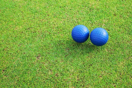Two ceramic golf ball on green grass の写真素材