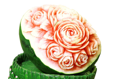 Cutting rose flowers on the surface of the watermelonの写真素材