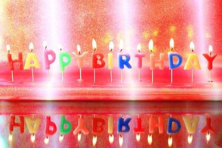 Birthday candles on colorful background の写真素材