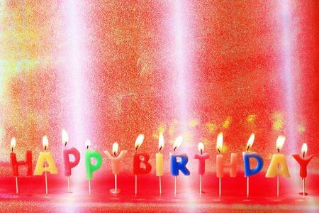 Birthday candles on colorful background の写真素材
